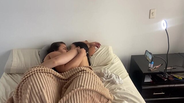 Lesbian sex under the covers on a cold morning