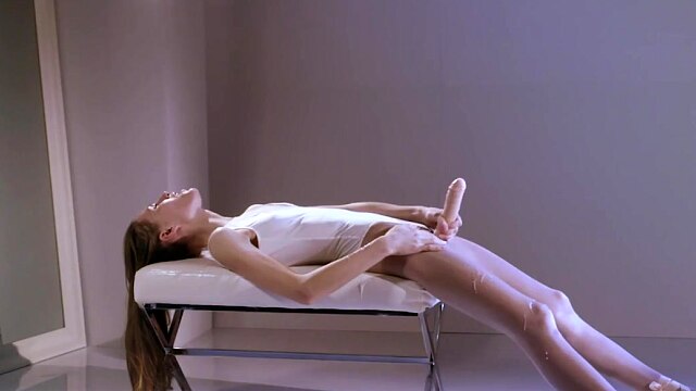 Stunning ballerina jerks off her strapless cock until it cums